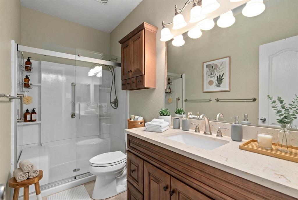 2617 Hollow Ridge Drive Denton, TX 76210 - Photo 25 of 32 a bathroom with a sink a toilet and shower