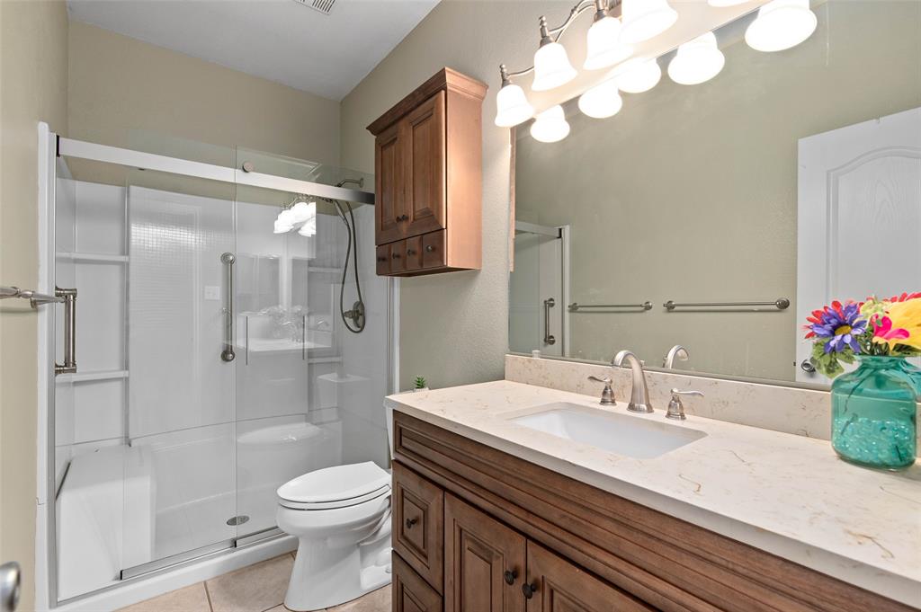 2617 Hollow Ridge Drive Denton, TX 76210 - Photo 26 of 32 a bathroom with a sink a toilet and shower