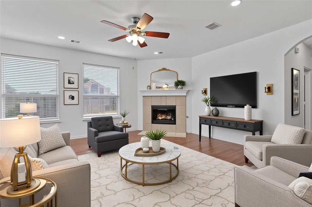 2617 Hollow Ridge Drive Denton, TX 76210 - Photo 3 of 32 a living room with furniture a fireplace and a flat screen tv