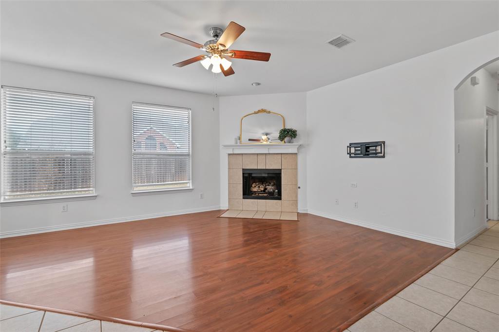 2617 Hollow Ridge Drive Denton, TX 76210 - Photo 4 of 32 an empty room with windows chandelier and fireplace