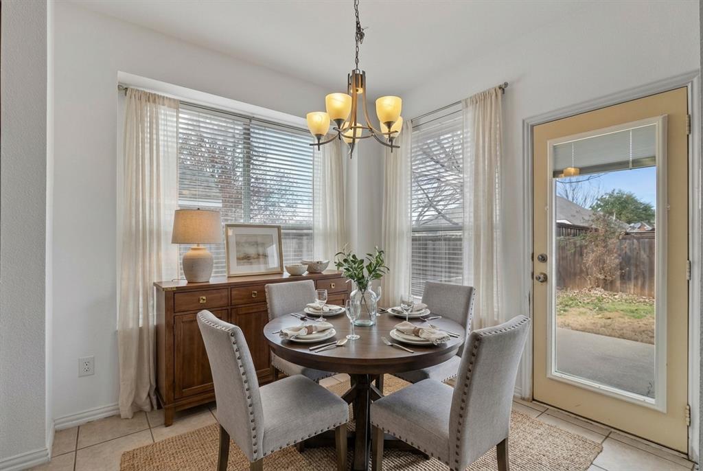 2617 Hollow Ridge Drive Denton, TX 76210 - Photo 8 of 32 a view of a dining room with furniture large windows and wooden floor