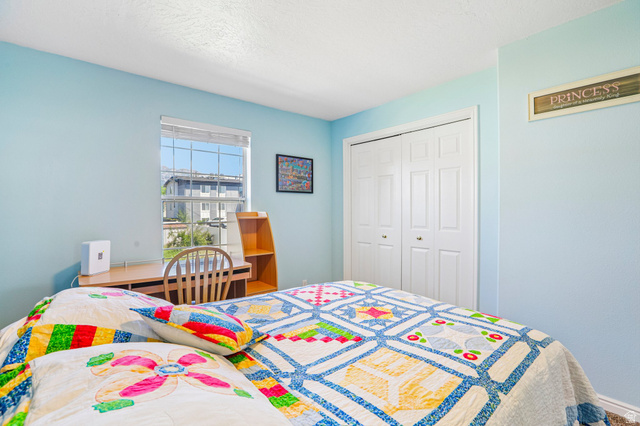 888 600 West, Unit 40 Provo, UT 84604 - Photo 12 of 19 Interior room featuring light blue walls, a window with horizontal blinds, and a built-in desk with shelving