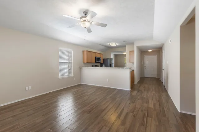 a view of a livingroom with hardwood floor and a ceiling fan