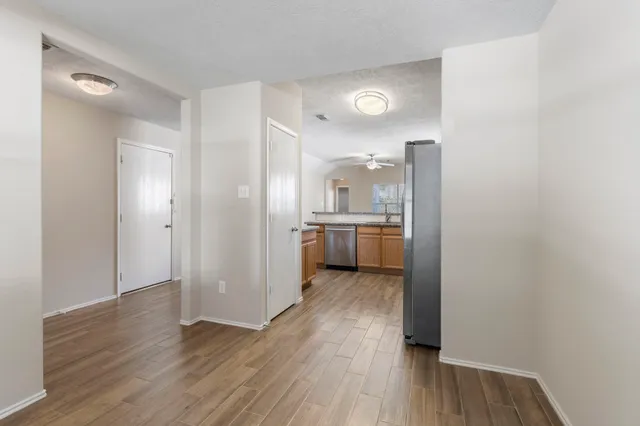 a view of a kitchen with wooden floor