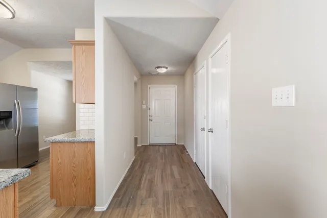 a view of a hallway with wooden floor