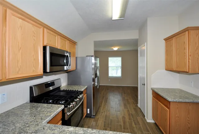 a kitchen with a stove and a microwave