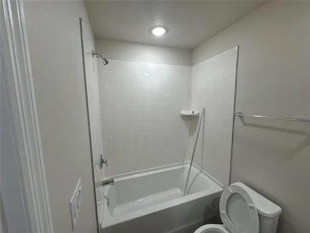 a bathroom with a shower and a toilet