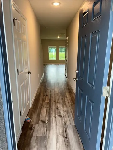 a view of gallery with wooden floor