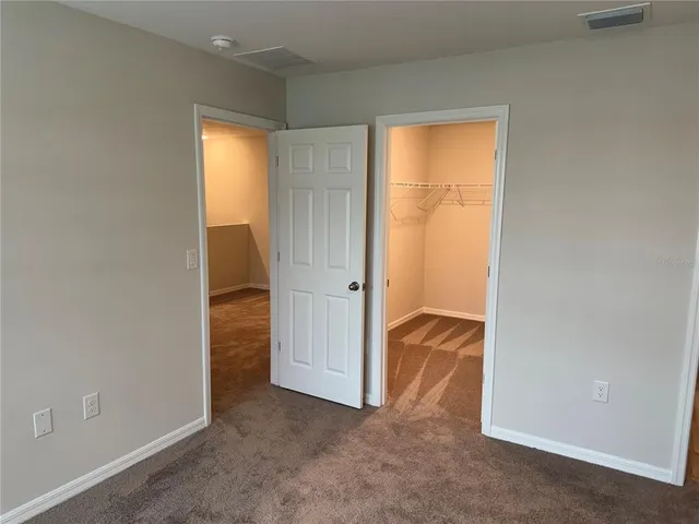an empty room with closet and a yard