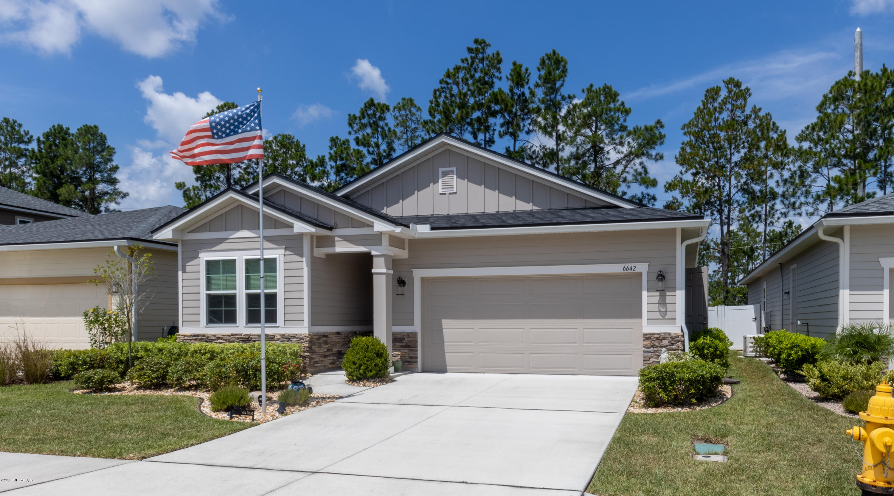 6642 Azalea Park Road Jacksonville, FL 32259 - Photo 1 of 42 a front view of a house with garden