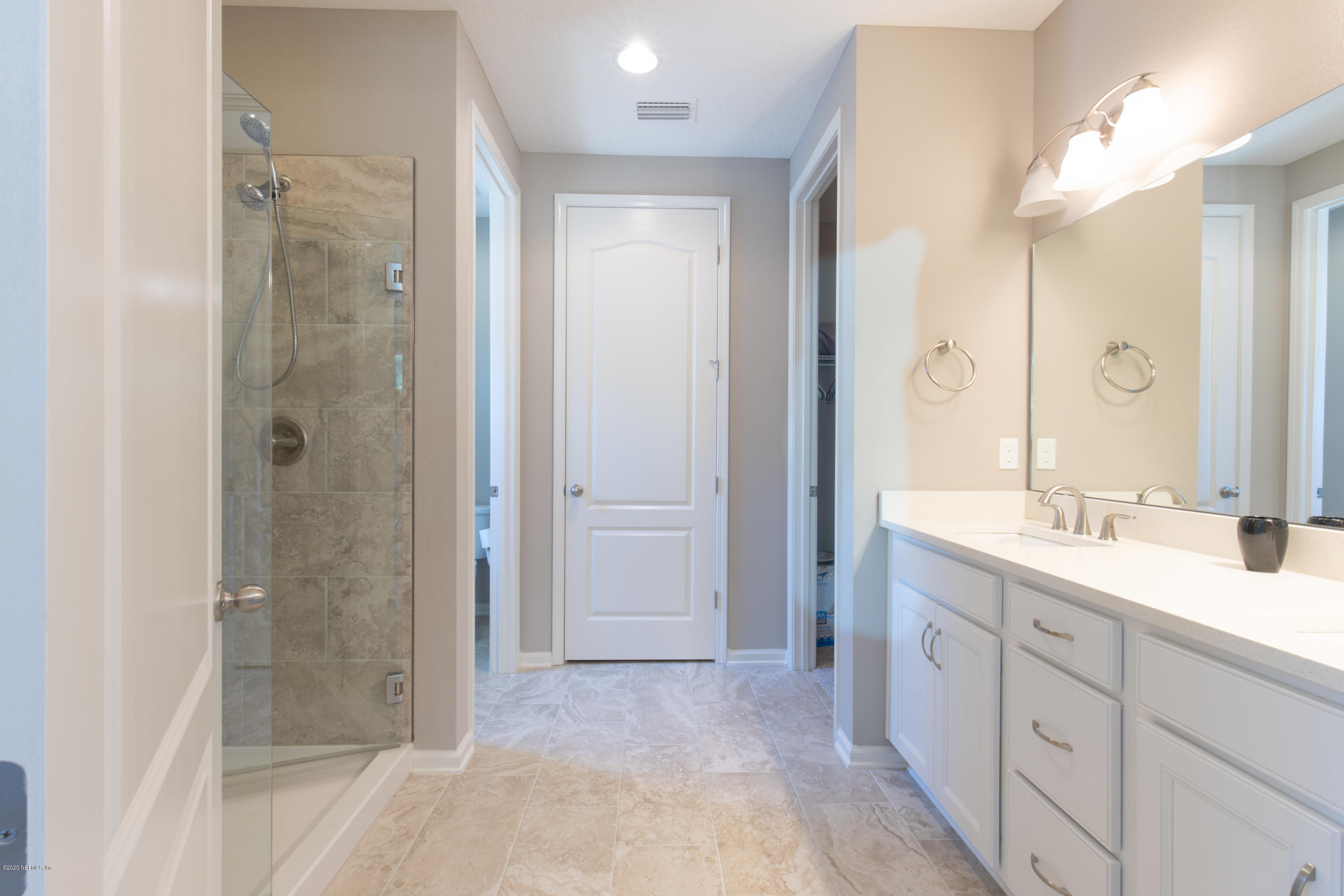 6642 Azalea Park Road Jacksonville, FL 32259 - Photo 22 of 42 a spacious bathroom with a shower sink and mirror