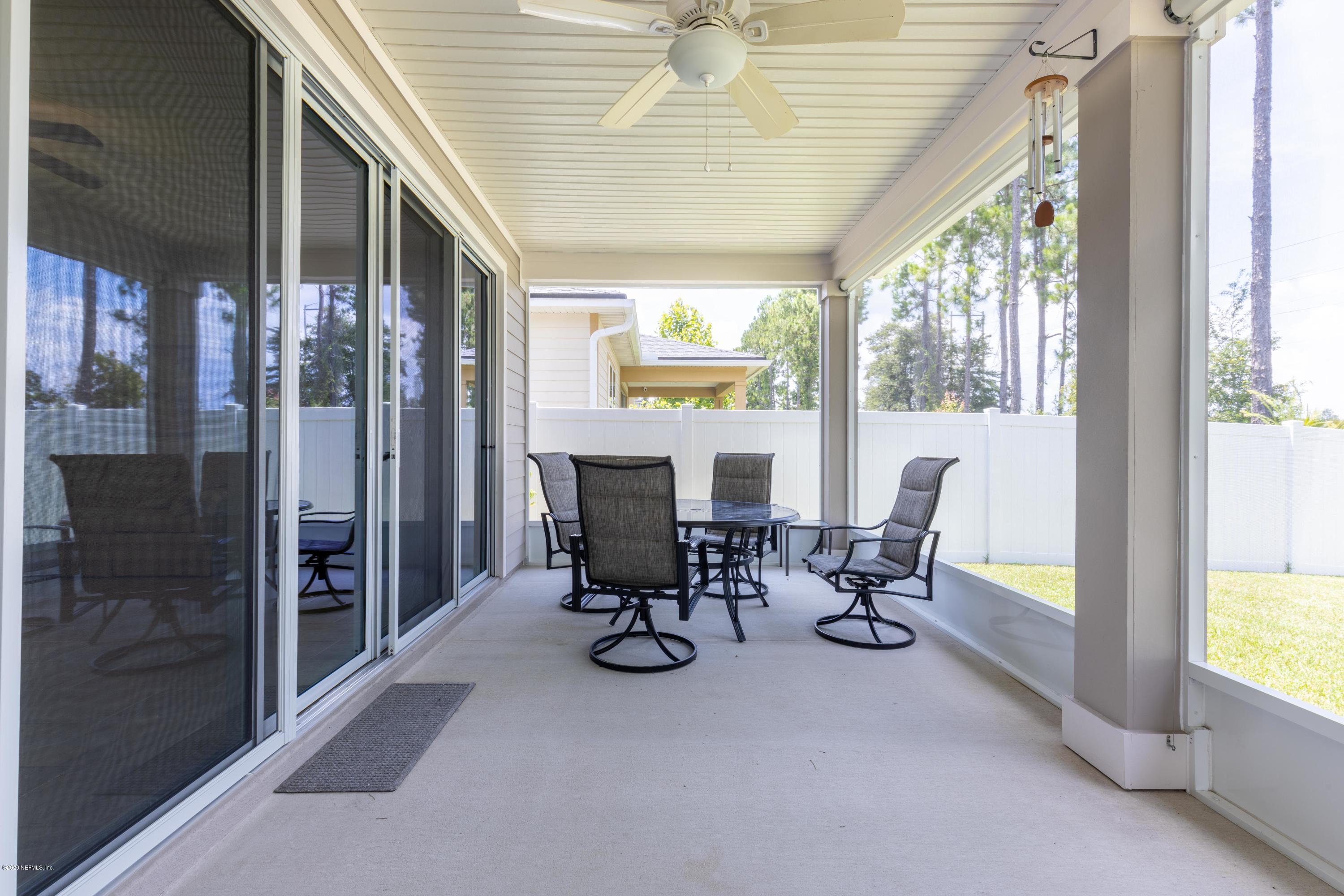 6642 Azalea Park Road Jacksonville, FL 32259 - Photo 25 of 42 a dining room with furniture water view and a floor to ceiling window