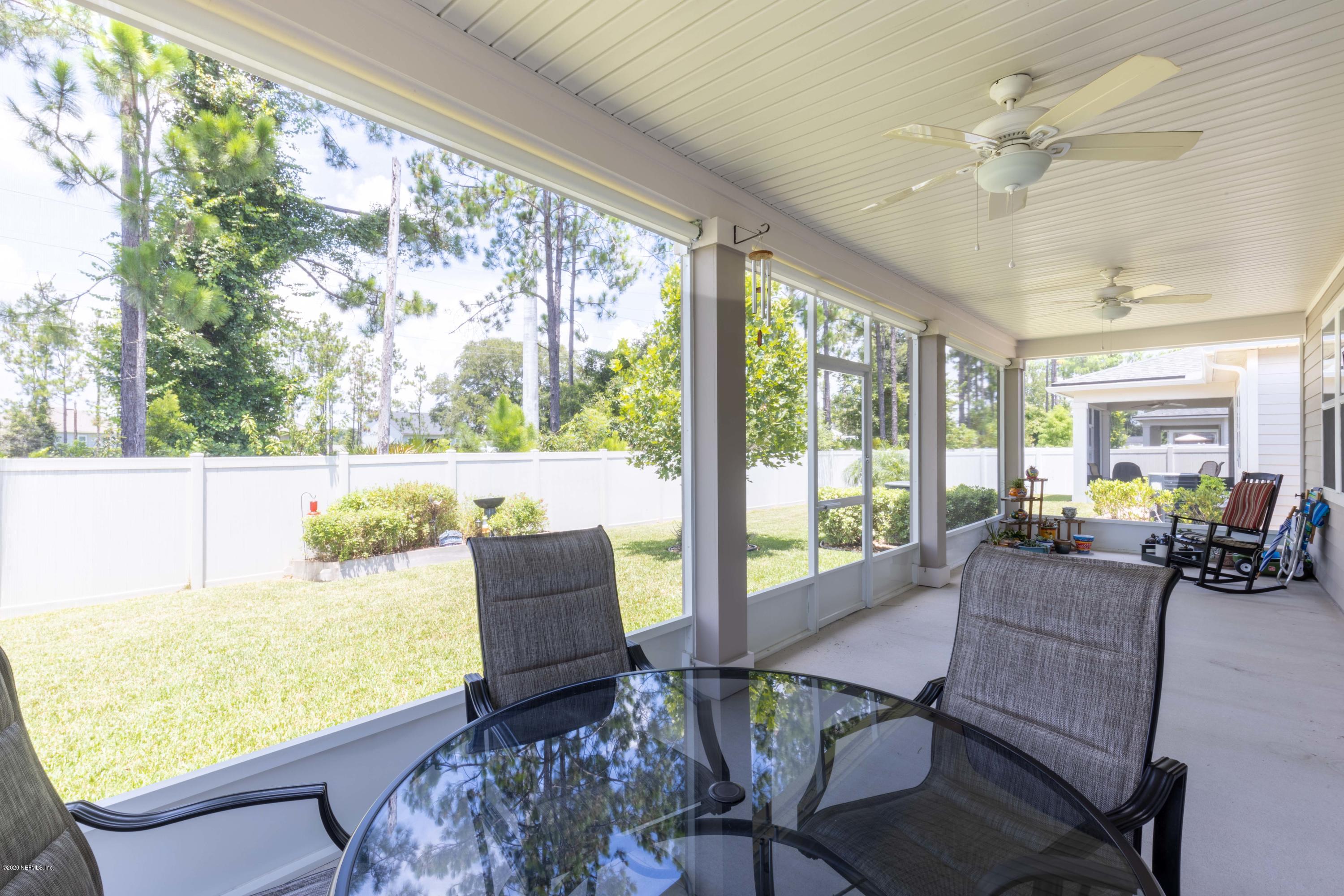 6642 Azalea Park Road Jacksonville, FL 32259 - Photo 28 of 42 a living room with furniture and large windows
