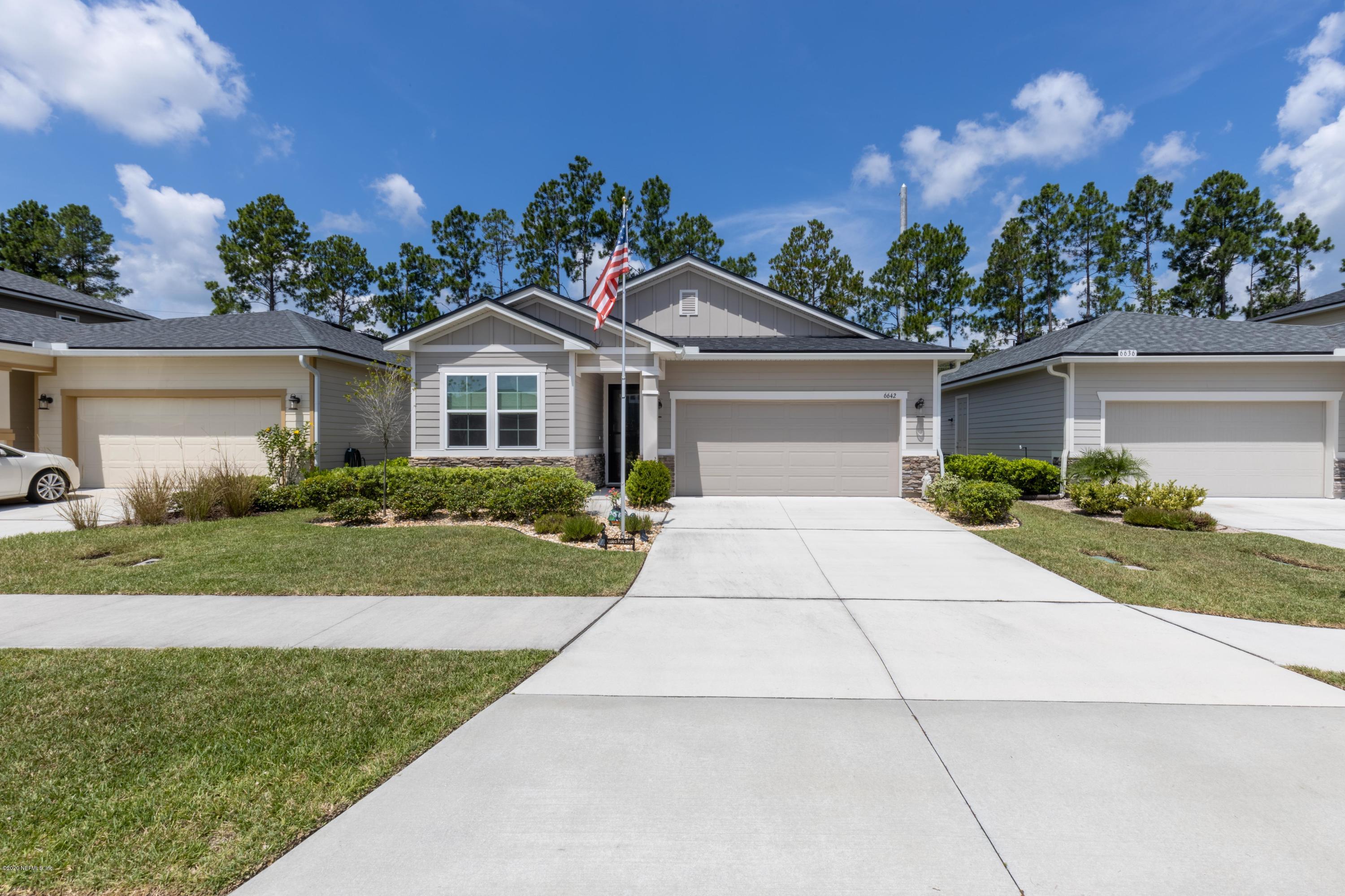 6642 Azalea Park Road Jacksonville, FL 32259 - Photo 29 of 42 a front view of a house with a yard and potted plants