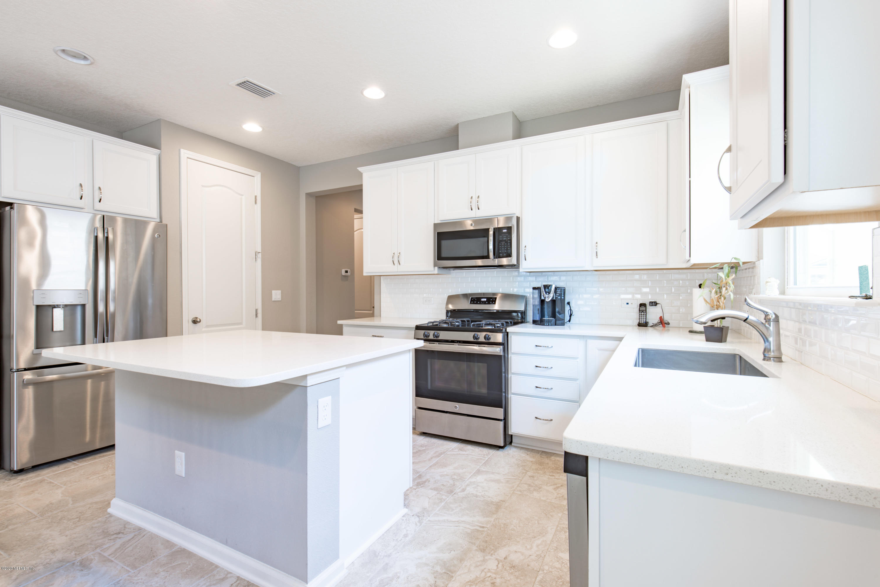 6642 Azalea Park Road Jacksonville, FL 32259 - Photo 3 of 42 a kitchen with a sink a stove a refrigerator and a sink