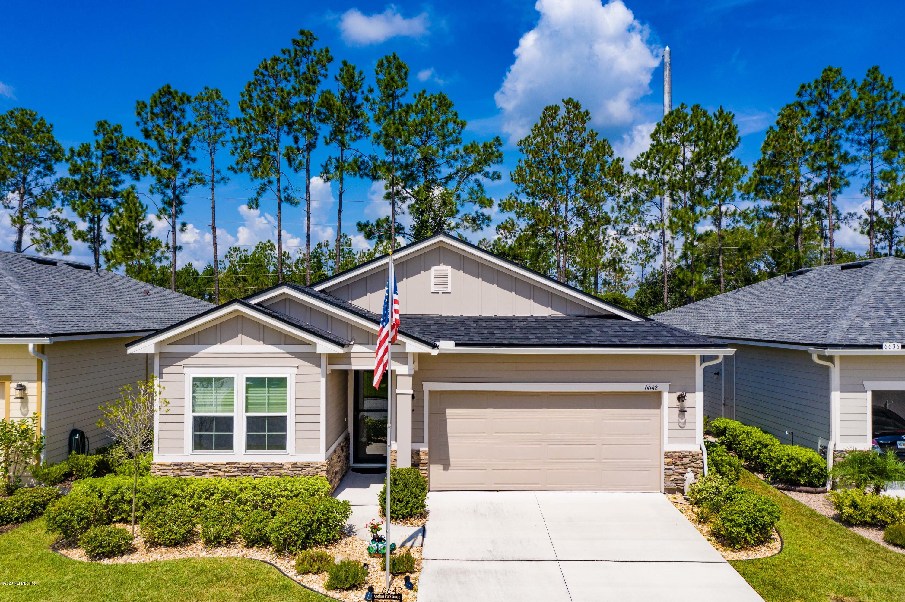 6642 Azalea Park Road Jacksonville, FL 32259 - Photo 39 of 42 a front view of a house with a yard and potted plants