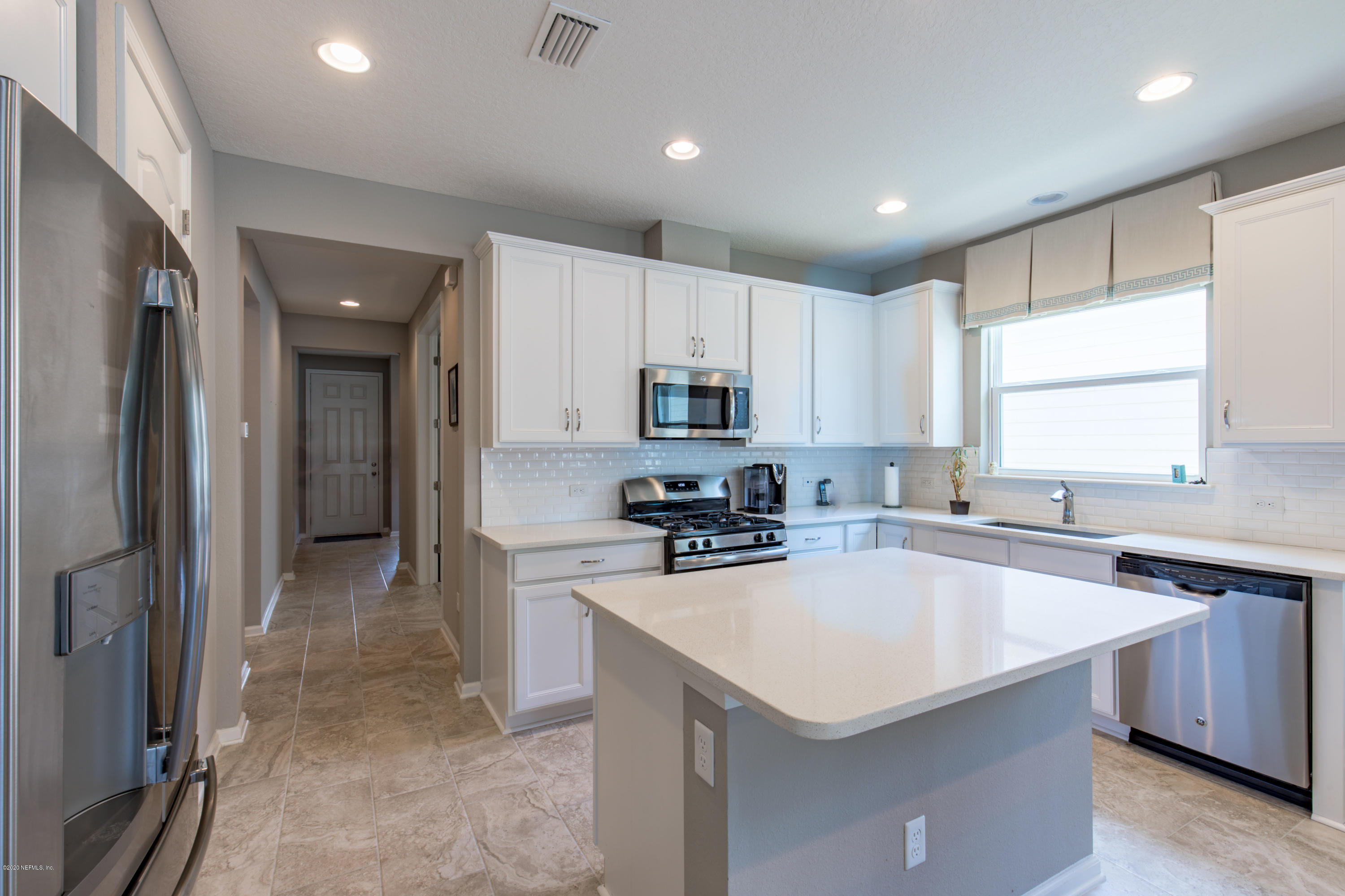 6642 Azalea Park Road Jacksonville, FL 32259 - Photo 4 of 42 a kitchen with a sink a stove a refrigerator and cabinets