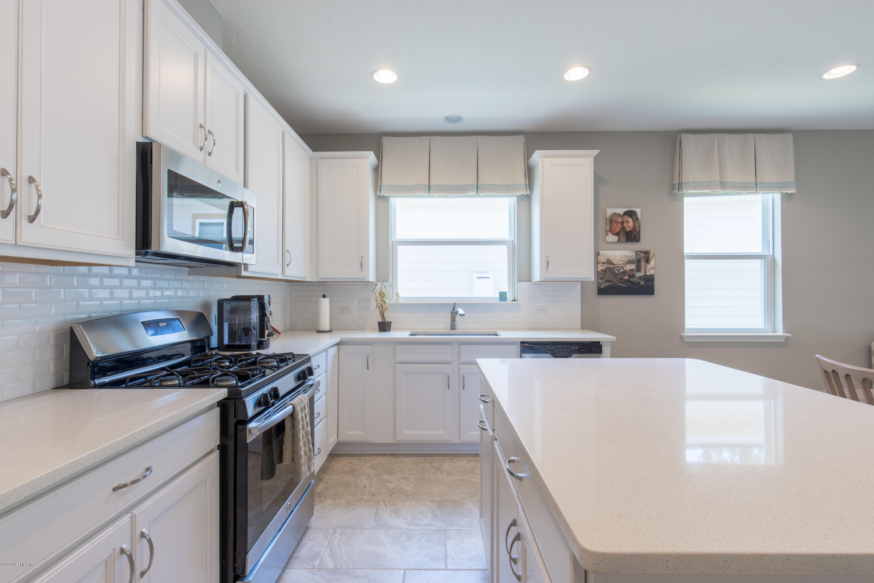 6642 Azalea Park Road Jacksonville, FL 32259 - Photo 6 of 42 a kitchen with stainless steel appliances granite countertop a stove a sink and a microwave