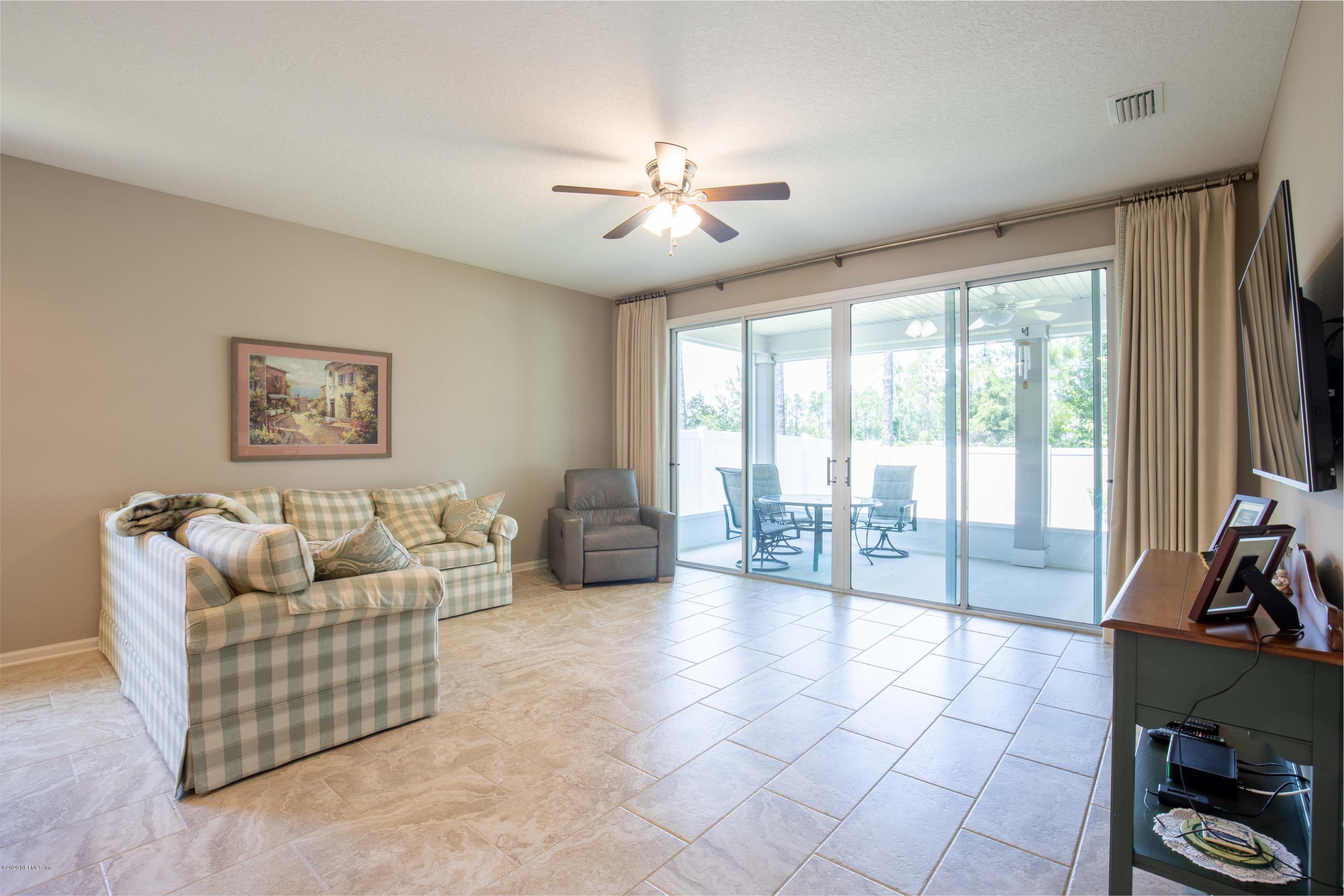 6642 Azalea Park Road Jacksonville, FL 32259 - Photo 10 of 42 a living room with furniture and a flat screen tv