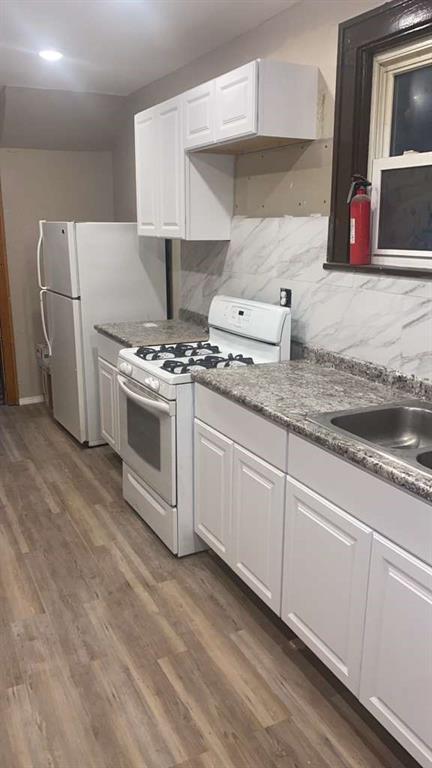 1408 Broadway Avenue McKees Rocks, PA 15136 - Photo 5 of 17 a kitchen with stainless steel appliances granite countertop a stove a sink and a microwave