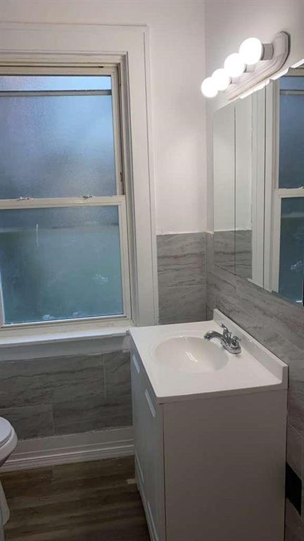 1408 Broadway Avenue McKees Rocks, PA 15136 - Photo 9 of 17 a bathroom with a sink a mirror and a bathtub