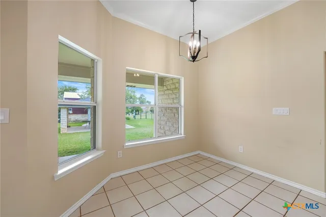a kitchen with white cabinets and appliances