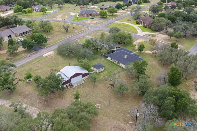 an aerial view of a house with a yard
