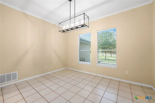 a view of an empty room and fire place