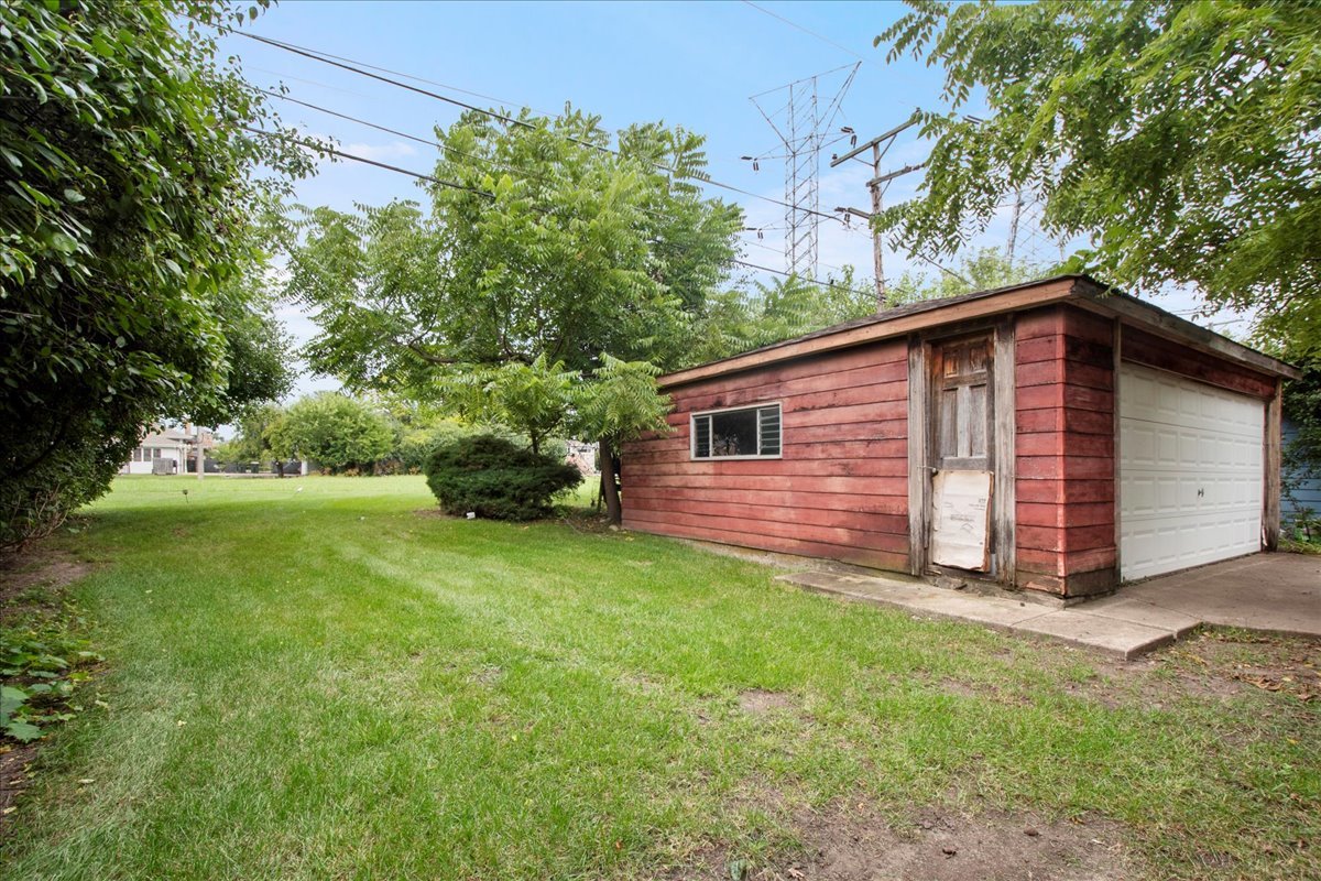 6638 Hazel Street Morton Grove, IL 60053 - Photo 17 of 19 a backyard of a house with plants and large trees