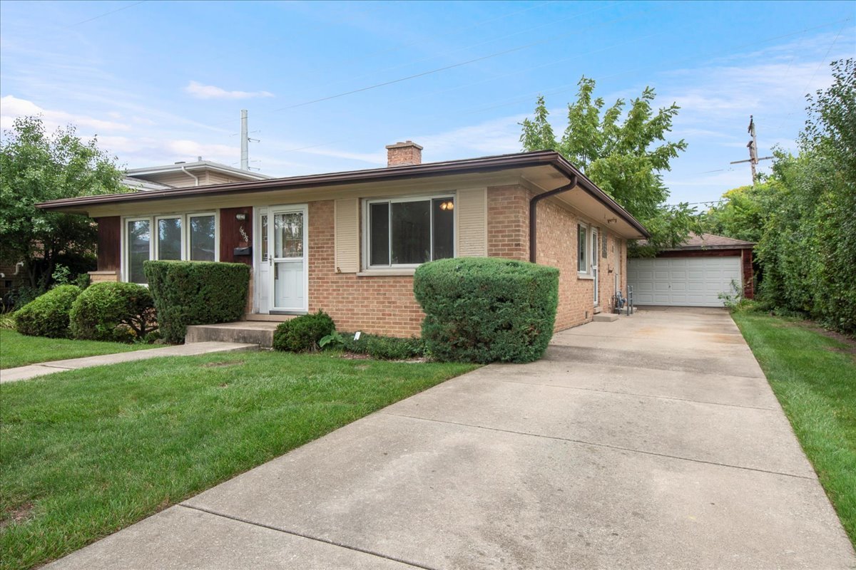 6638 Hazel Street Morton Grove, IL 60053 - Photo 2 of 19 a front view of a house with a yard and potted plants