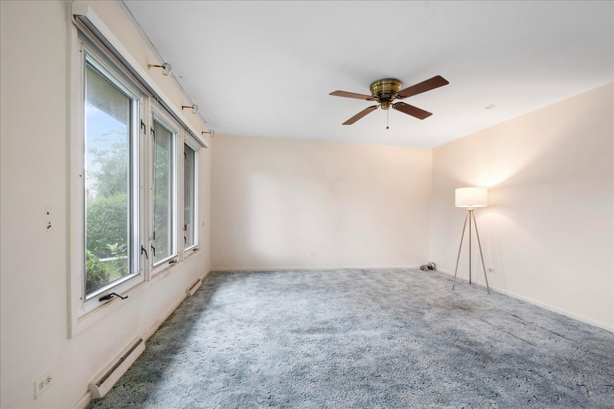 6638 Hazel Street Morton Grove, IL 60053 - Photo 3 of 19 a view of a livingroom with a ceiling fan and window