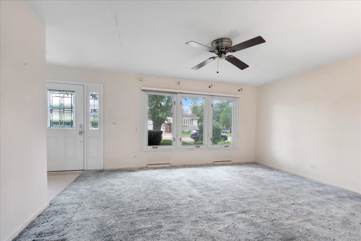 6638 Hazel Street Morton Grove, IL 60053 - Photo 4 of 19 a view of room with window and ceiling fan