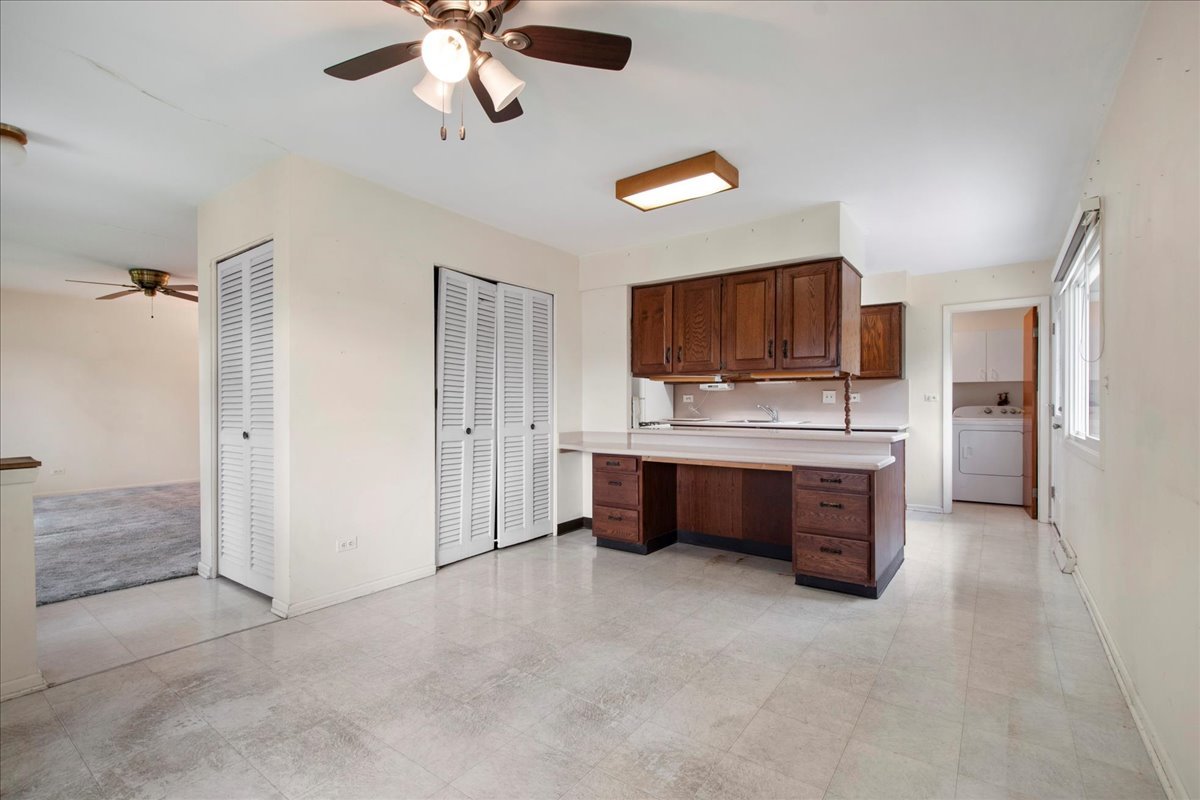 6638 Hazel Street Morton Grove, IL 60053 - Photo 8 of 19 a large kitchen with a refrigerator and a stove top oven