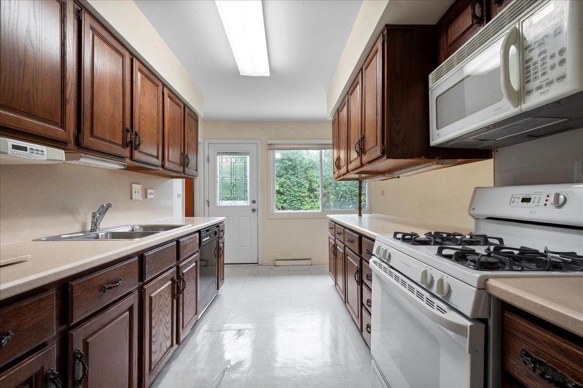 6638 Hazel Street Morton Grove, IL 60053 - Photo 10 of 19 a kitchen with stainless steel appliances granite countertop a stove a sink dishwasher and cabinets with wooden floor