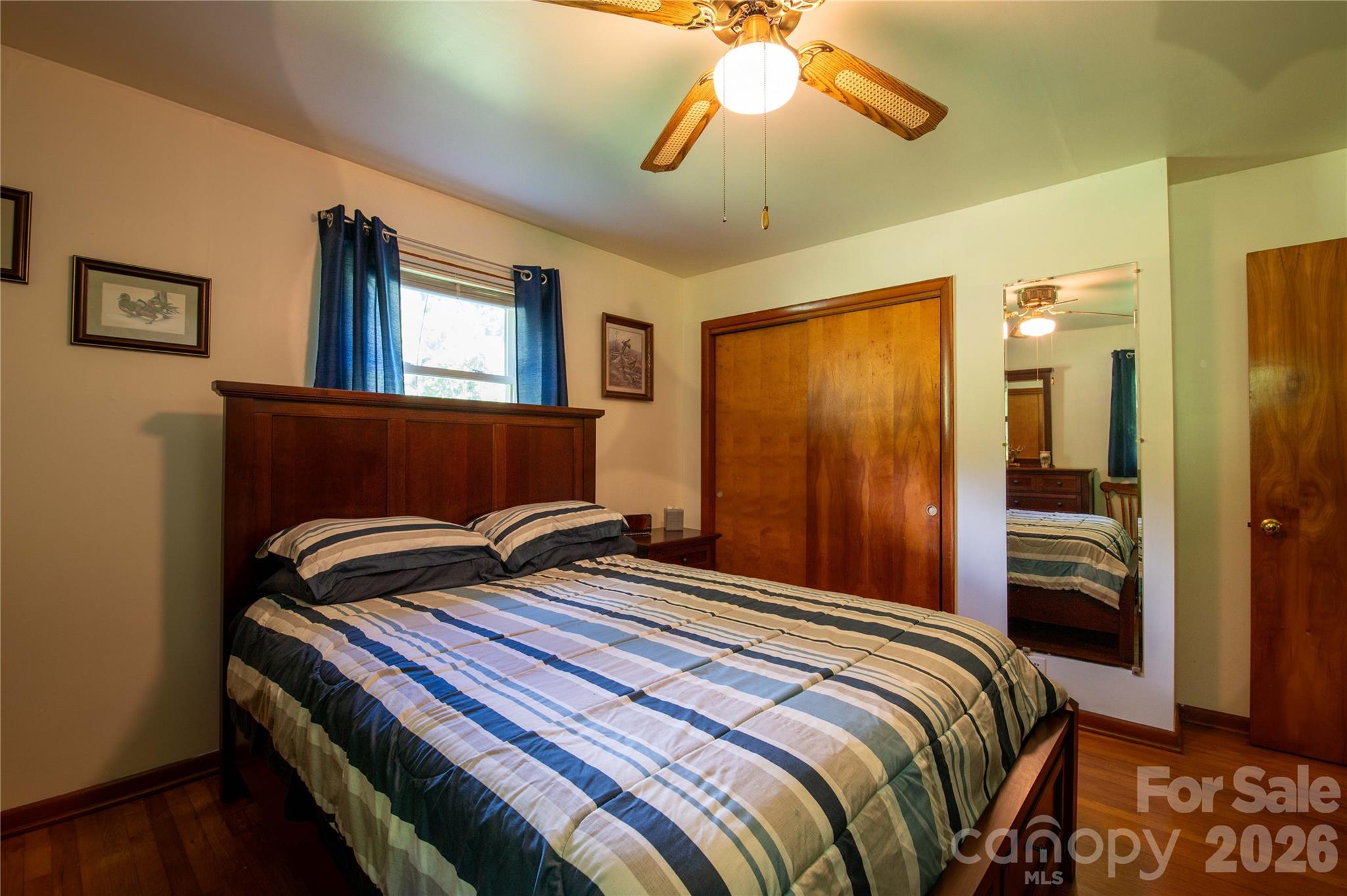 40 Double Island Road Burnsville, NC 28714 - Photo 24 of 38 a bedroom with a bed and a chandelier