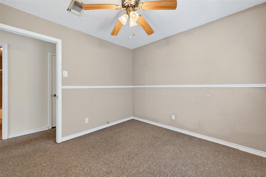 606 South Gordon Street Sherman, TX 75092 - Photo 11 of 22 an empty room with a chandelier fan