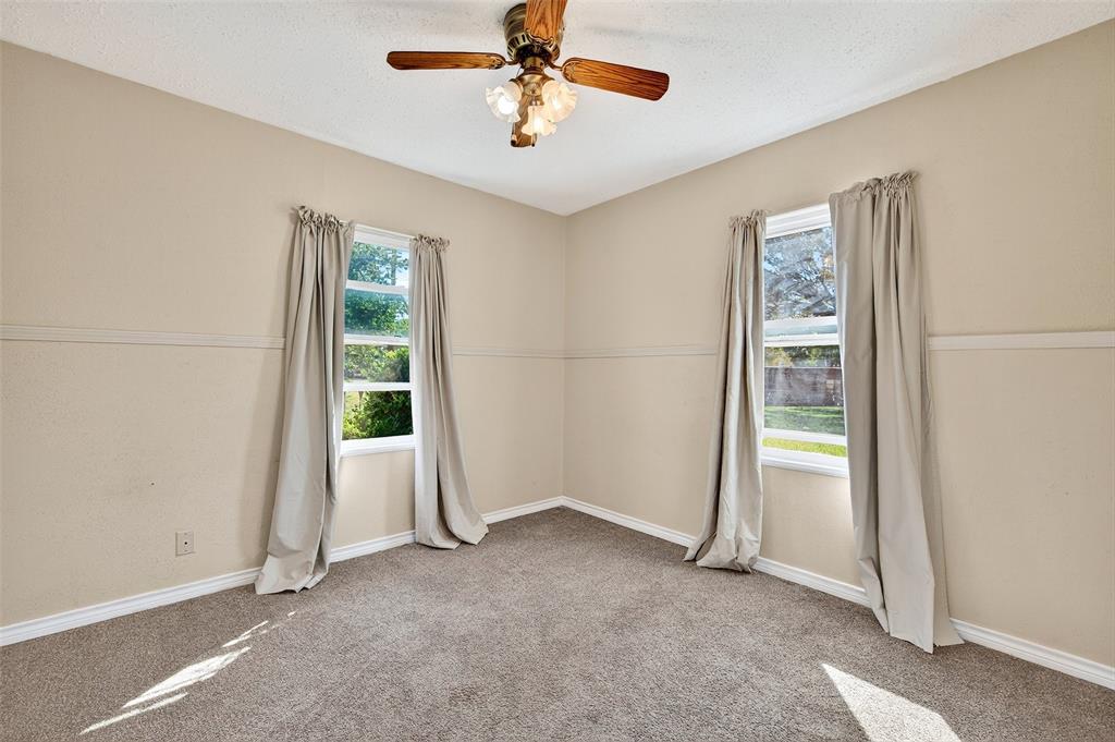 606 South Gordon Street Sherman, TX 75092 - Photo 14 of 22 an empty room with windows and fan