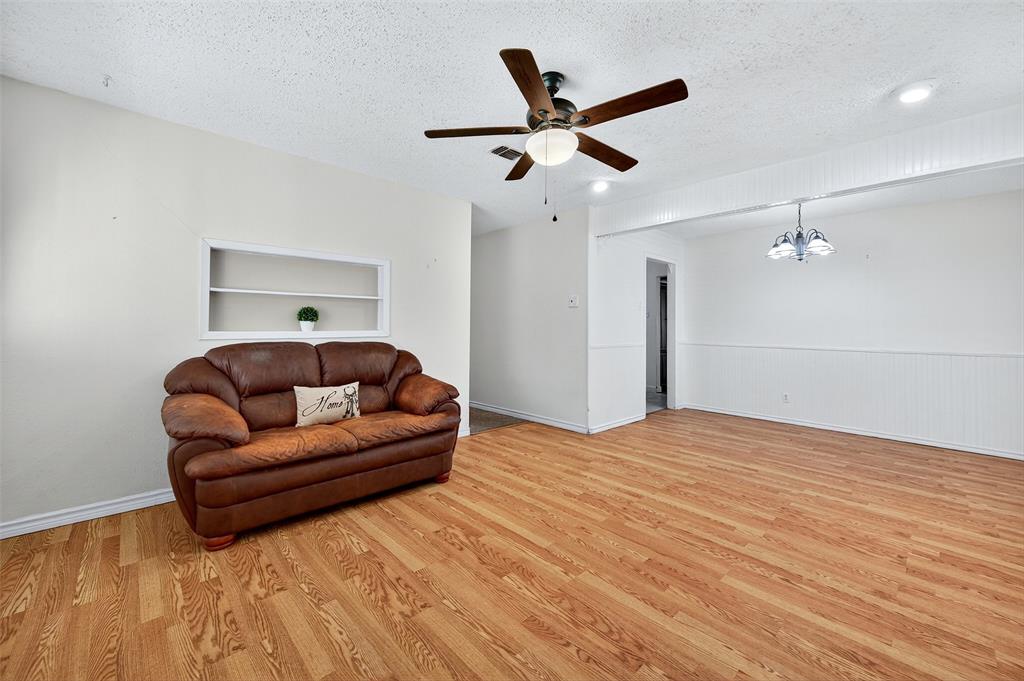 606 South Gordon Street Sherman, TX 75092 - Photo 4 of 22 a living room with a bed furniture and ceiling fan