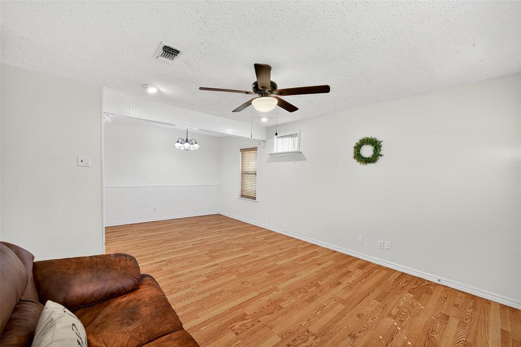 606 South Gordon Street Sherman, TX 75092 - Photo 7 of 22 a bedroom with a bed and a chandelier