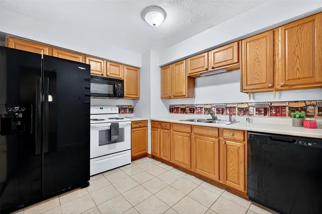 a kitchen with stainless steel appliances granite countertop a refrigerator sink and cabinets