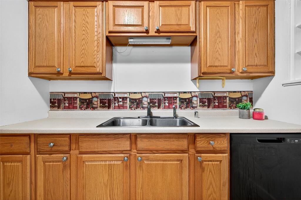 606 South Gordon Street Sherman, TX 75092 - Photo 9 of 22 a kitchen with stainless steel appliances granite countertop a sink and cabinets