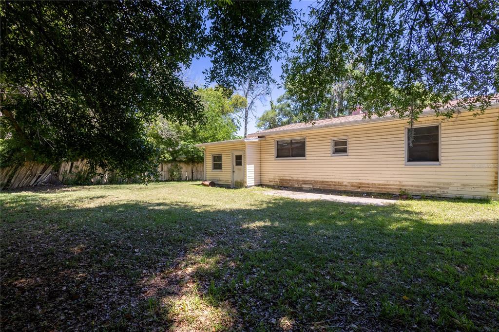6281 Southeast Hames Road Belleview, FL 34420 - Photo 14 of 16 a view of a yard with a house and a large tree