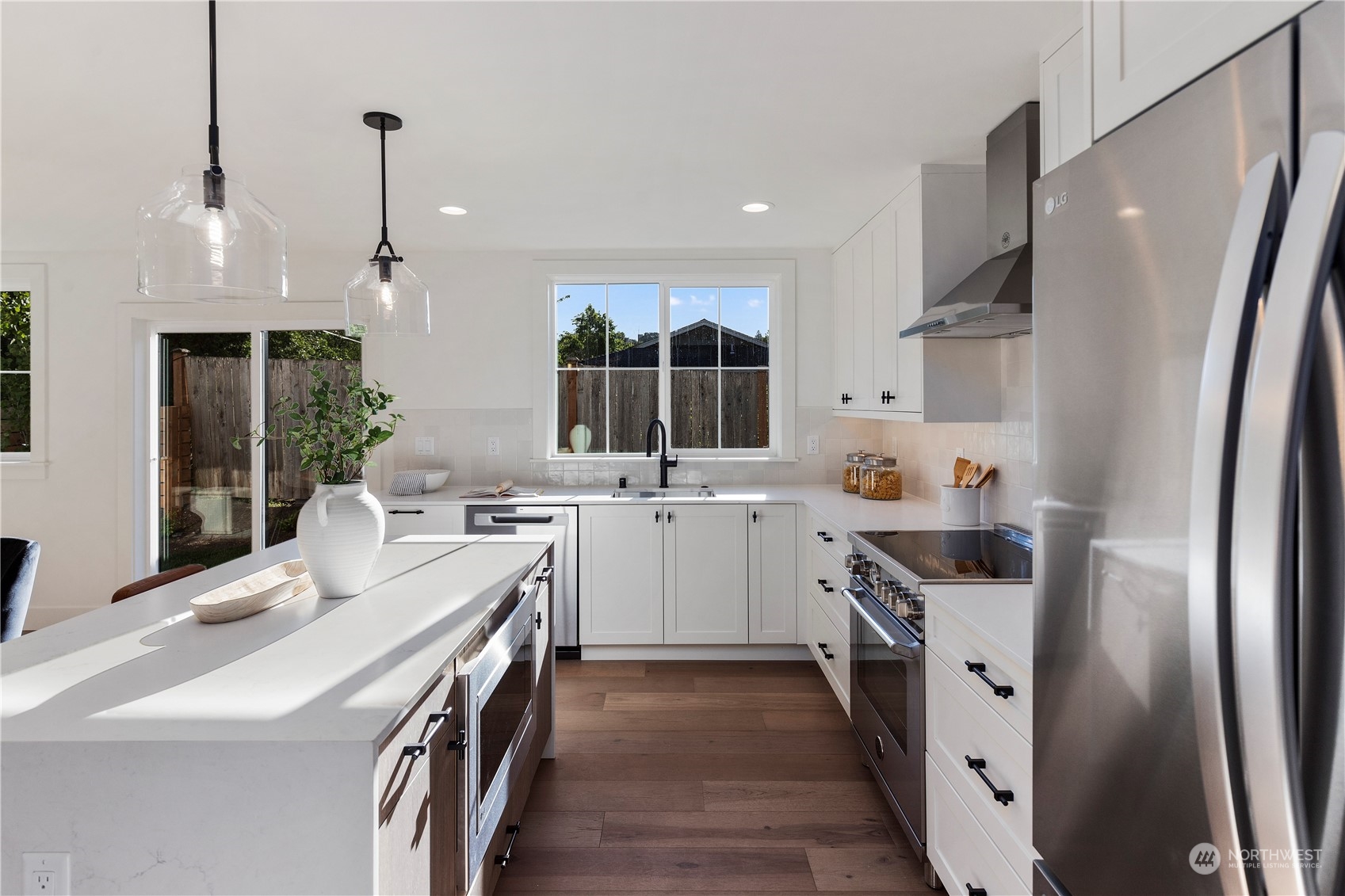 3014 East Howell Street Seattle, WA 98122 - Photo 12 of 39 a kitchen with white cabinets and white appliances