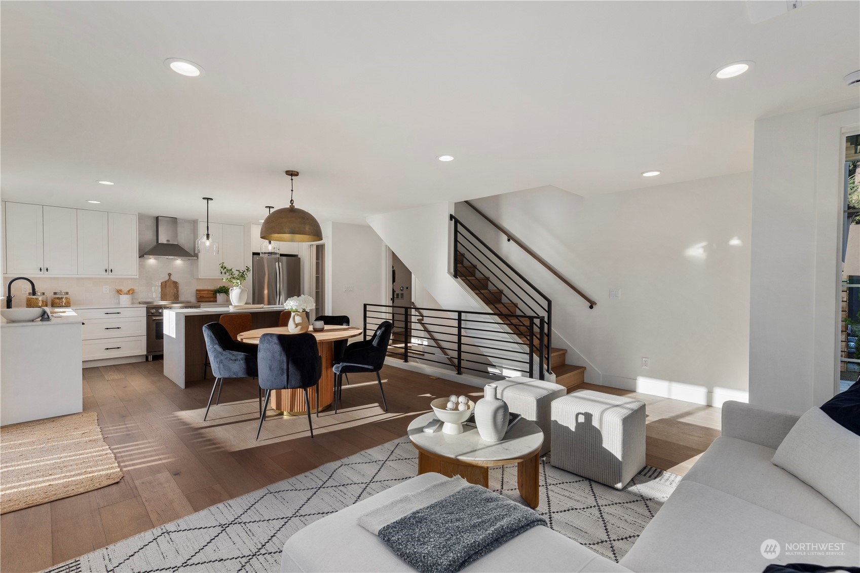 3014 East Howell Street Seattle, WA 98122 - Photo 15 of 39 a living room with couches and kitchen view with wooden floor