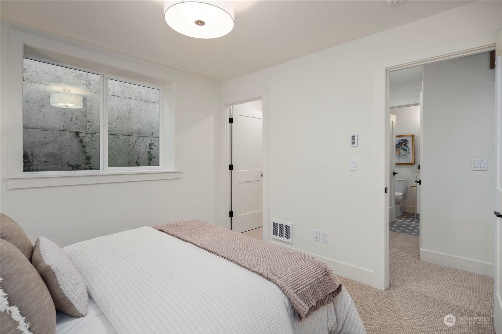 3014 East Howell Street Seattle, WA 98122 - Photo 30 of 39 a bedroom with a bed and a large window