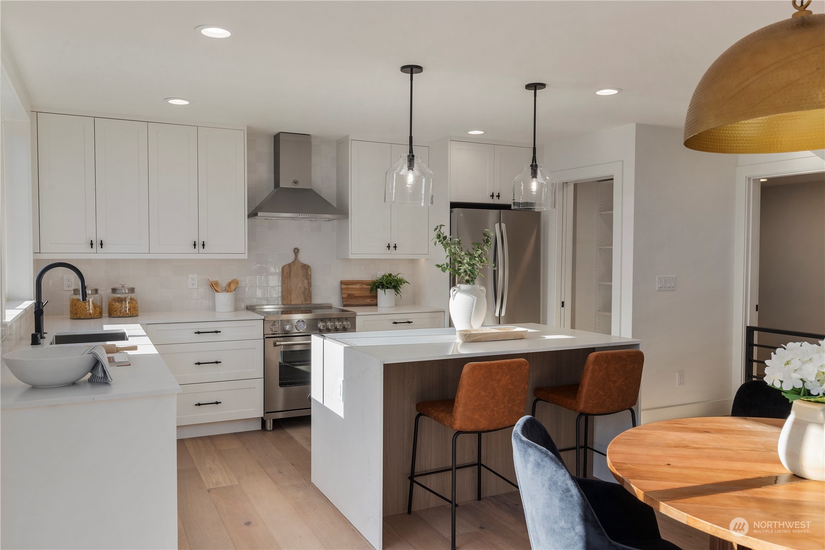 3014 East Howell Street Seattle, WA 98122 - Photo 6 of 39 a kitchen with white cabinets and stainless steel appliances