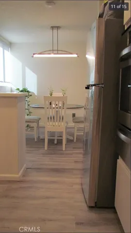 a view of a kitchen with furniture and wooden floor