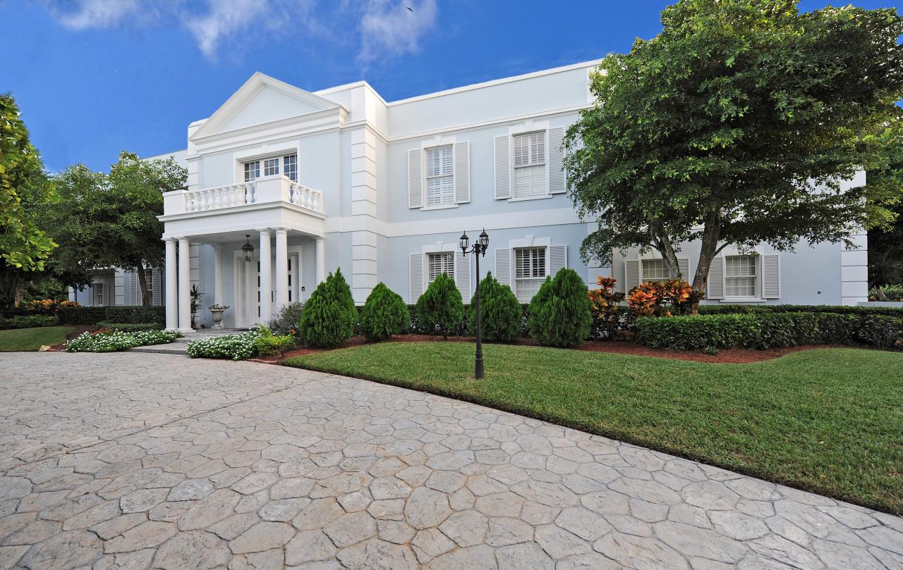 202 Indian Road Palm Beach, FL 33480 - Photo 2 of 24 a view of a white house next to a yard with big trees
