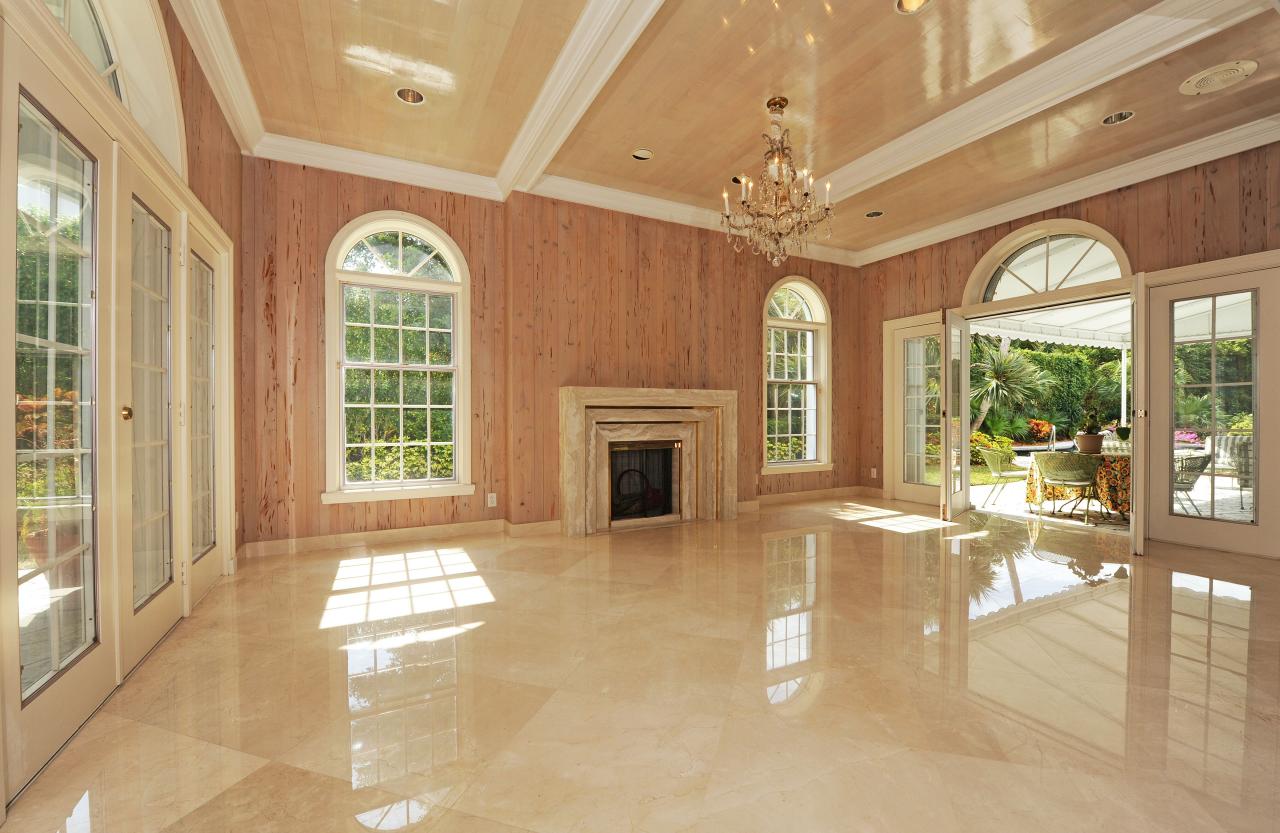 202 Indian Road Palm Beach, FL 33480 - Photo 11 of 24 a view of a livingroom with a fireplace a ceiling fan and windows