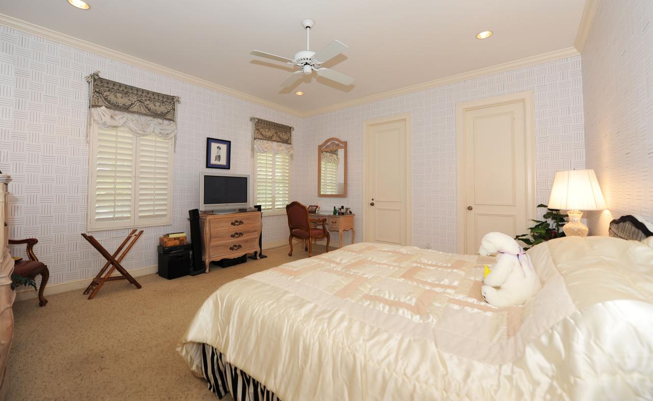 202 Indian Road Palm Beach, FL 33480 - Photo 20 of 24 a bedroom with a bed and a chandelier